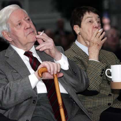 Helmut Schmidt and his wife Loki enjoy a cigarette at a New Year event in Hamburg